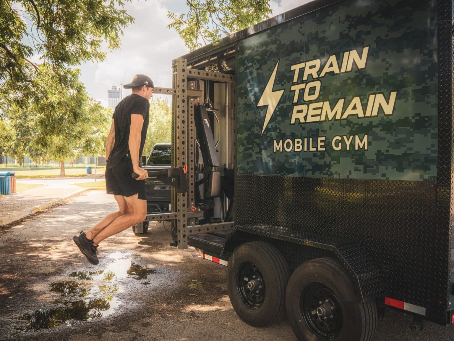 A client training with a coach beside the trailer